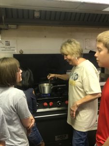 This photograph is of Linda Long interacting and having a conversation with children, which conveys our vision to truly devout ourselves to honing the artistic abilities of our students.